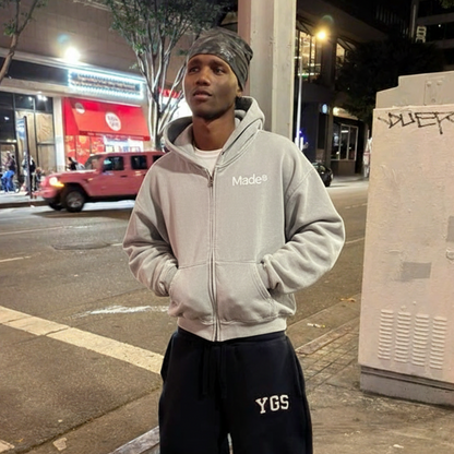 Model wearing a gray "Made®" zip-up hoodie.