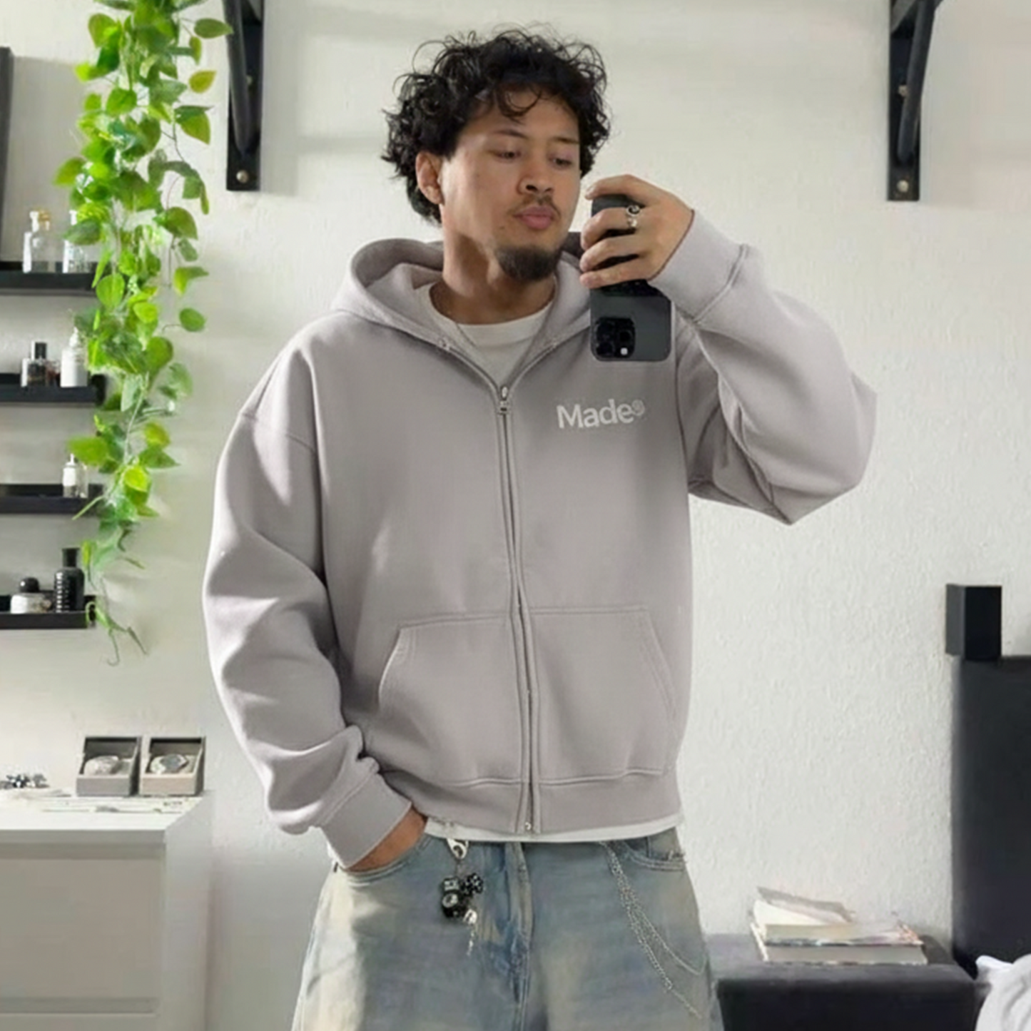 Model wearing a gray "Made®" zip-up hoodie.