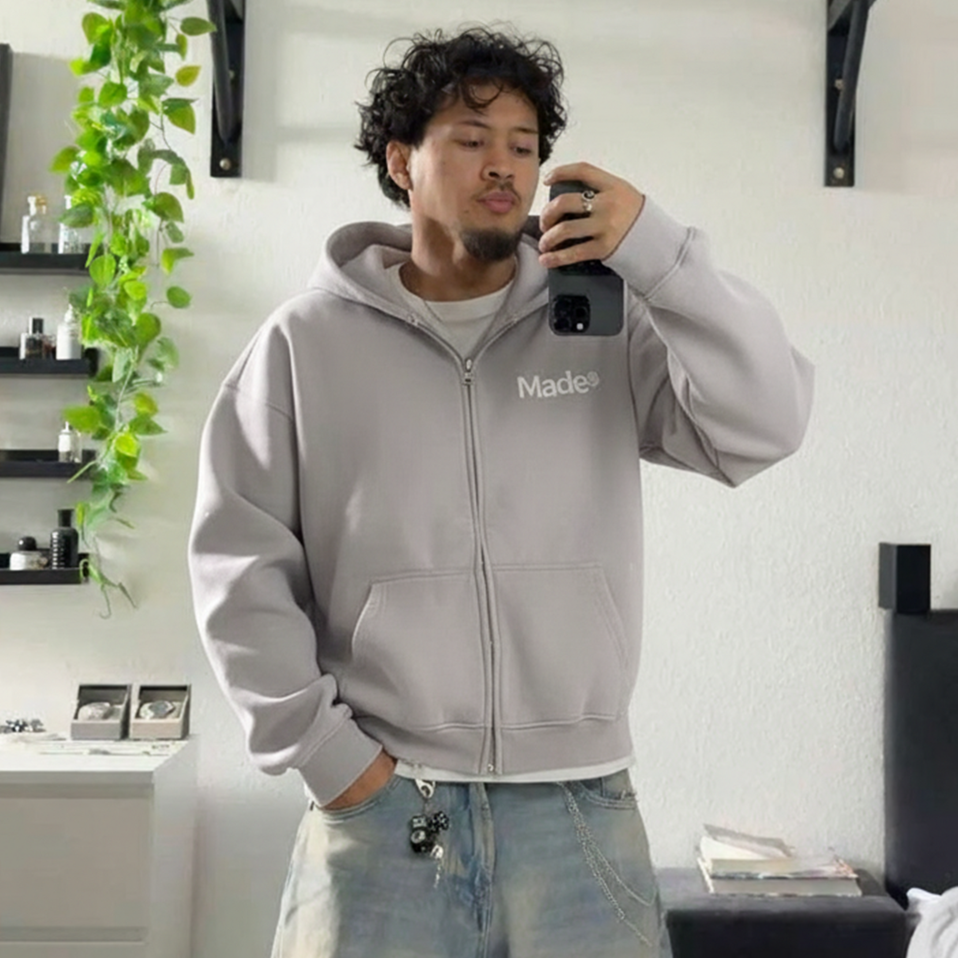 Model wearing a gray "Made®" zip-up hoodie.