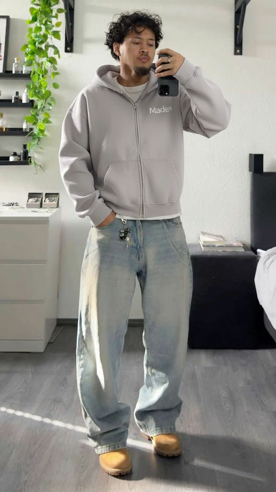 Model wearing a gray "Made®" zip-up hoodie. (Vertical)